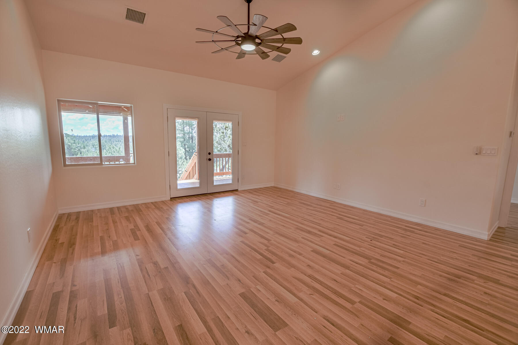 2956 Lodgepole Road Overgaard, AZ 85933 - Photo 15 of 34 a view of an empty room with wooden floor and a window