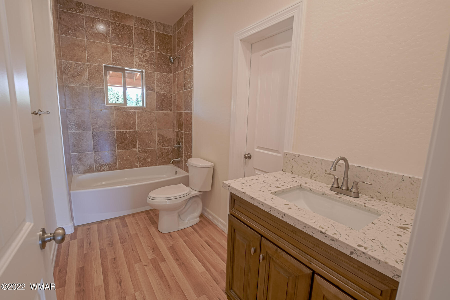 2956 Lodgepole Road Overgaard, AZ 85933 - Photo 25 of 34 a bathroom with a granite countertop sink a toilet and shower