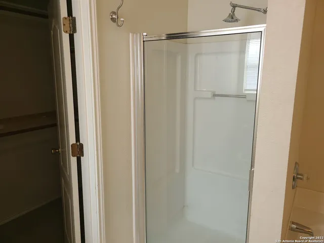 a bathroom with a glass shower door