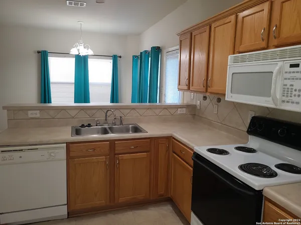 a kitchen with a sink stove and cabinets