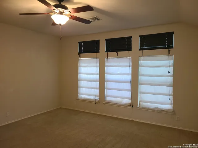 a view of room with a ceiling fan