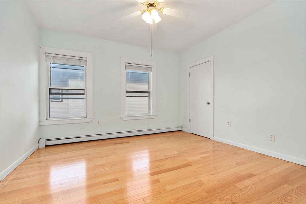 3266 Washington Street, Unit 3F Boston, MA 02130 - Photo 11 of 20 a view of empty room with wooden floor and fan