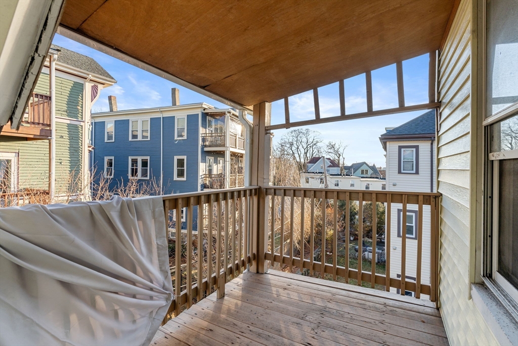3266 Washington Street, Unit 3F Boston, MA 02130 - Photo 13 of 20 a view of a brick house with large windows and a table