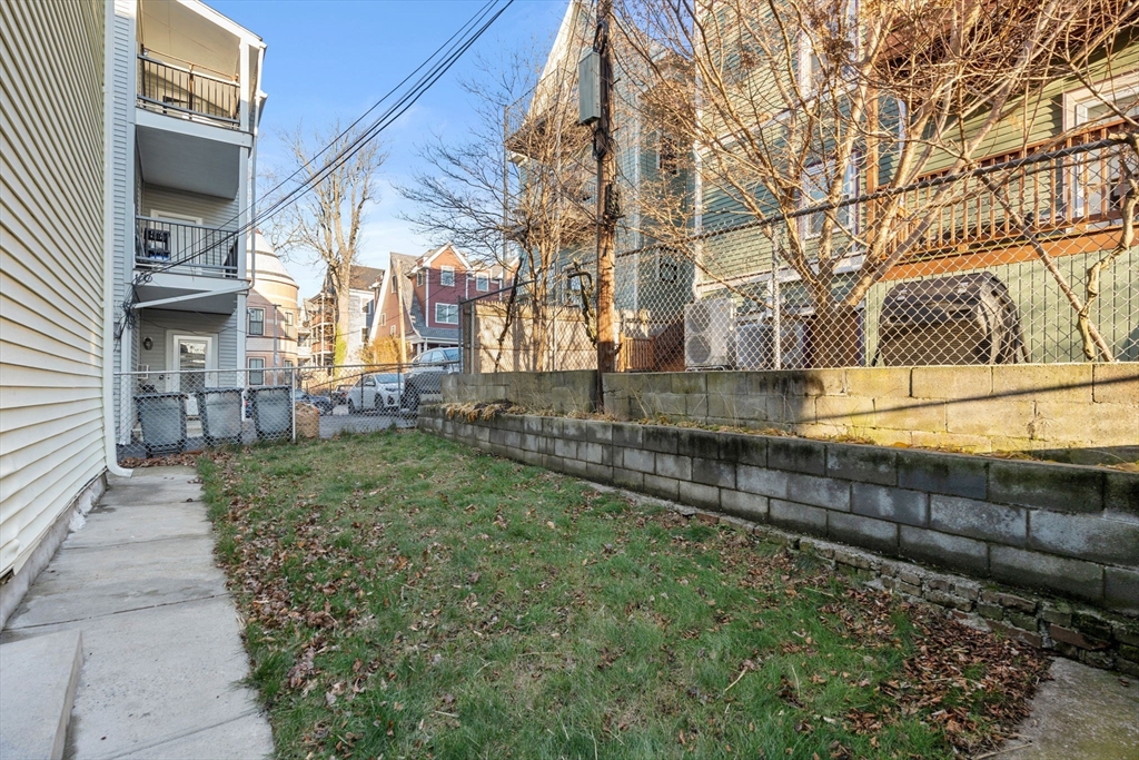 3266 Washington Street, Unit 3F Boston, MA 02130 - Photo 15 of 20 a view of a yard with a house and a trees