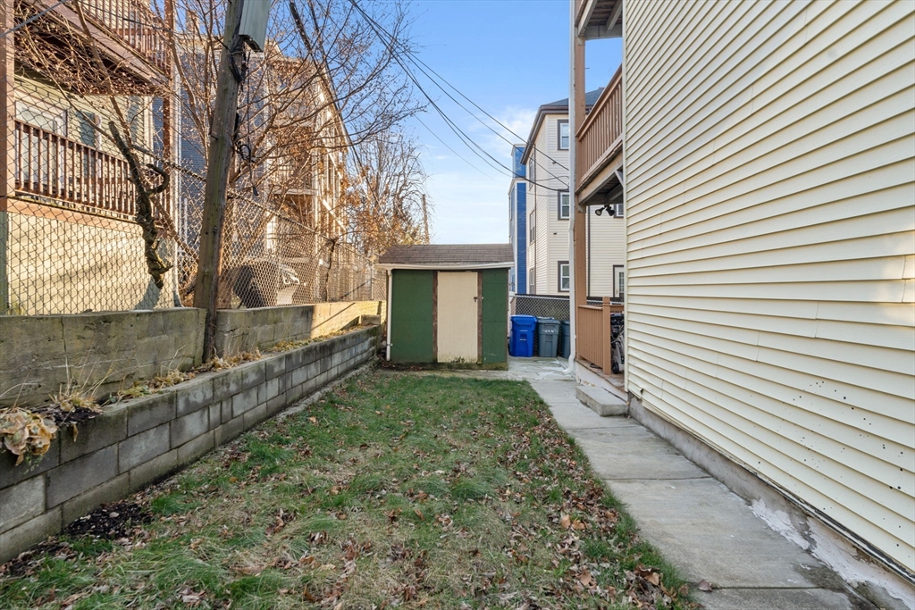 3266 Washington Street, Unit 3F Boston, MA 02130 - Photo 16 of 20 a view of a house with a yard and a garage
