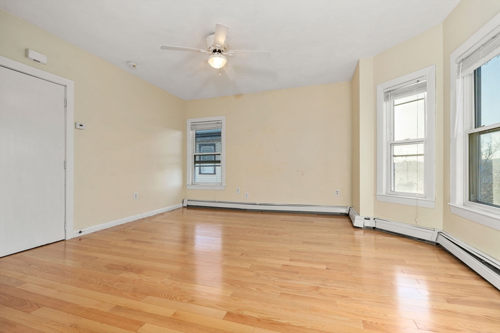 3266 Washington Street, Unit 3F Boston, MA 02130 - Photo 6 of 20 a view of an empty room with a window and wooden floor