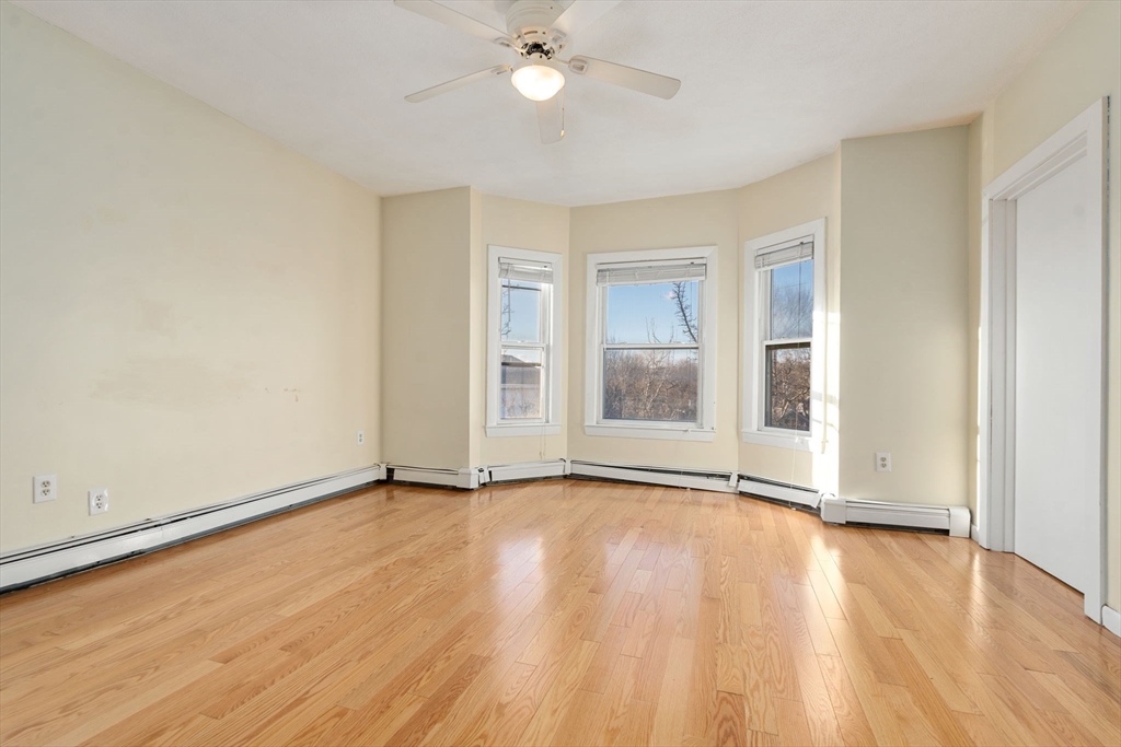 3266 Washington Street, Unit 3F Boston, MA 02130 - Photo 7 of 20 a view of an empty room with wooden floor