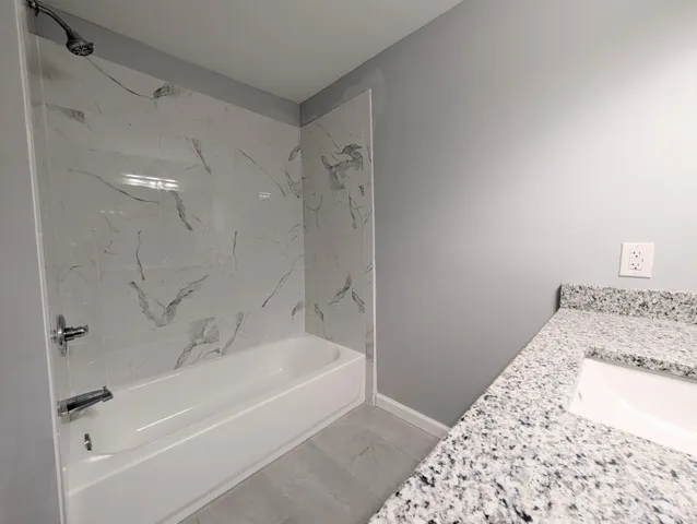 a bathroom with a bathtub and a shower