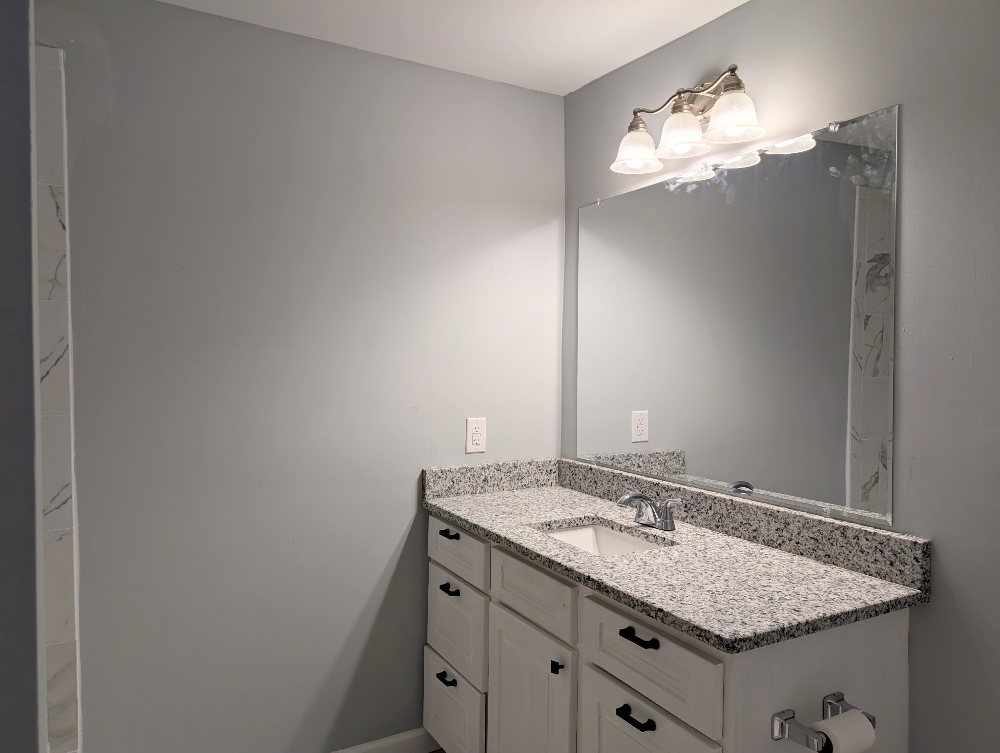 406 Horton Street Decherd, TN 37324 - Photo 19 of 24 a bathroom with a granite countertop sink and a mirror