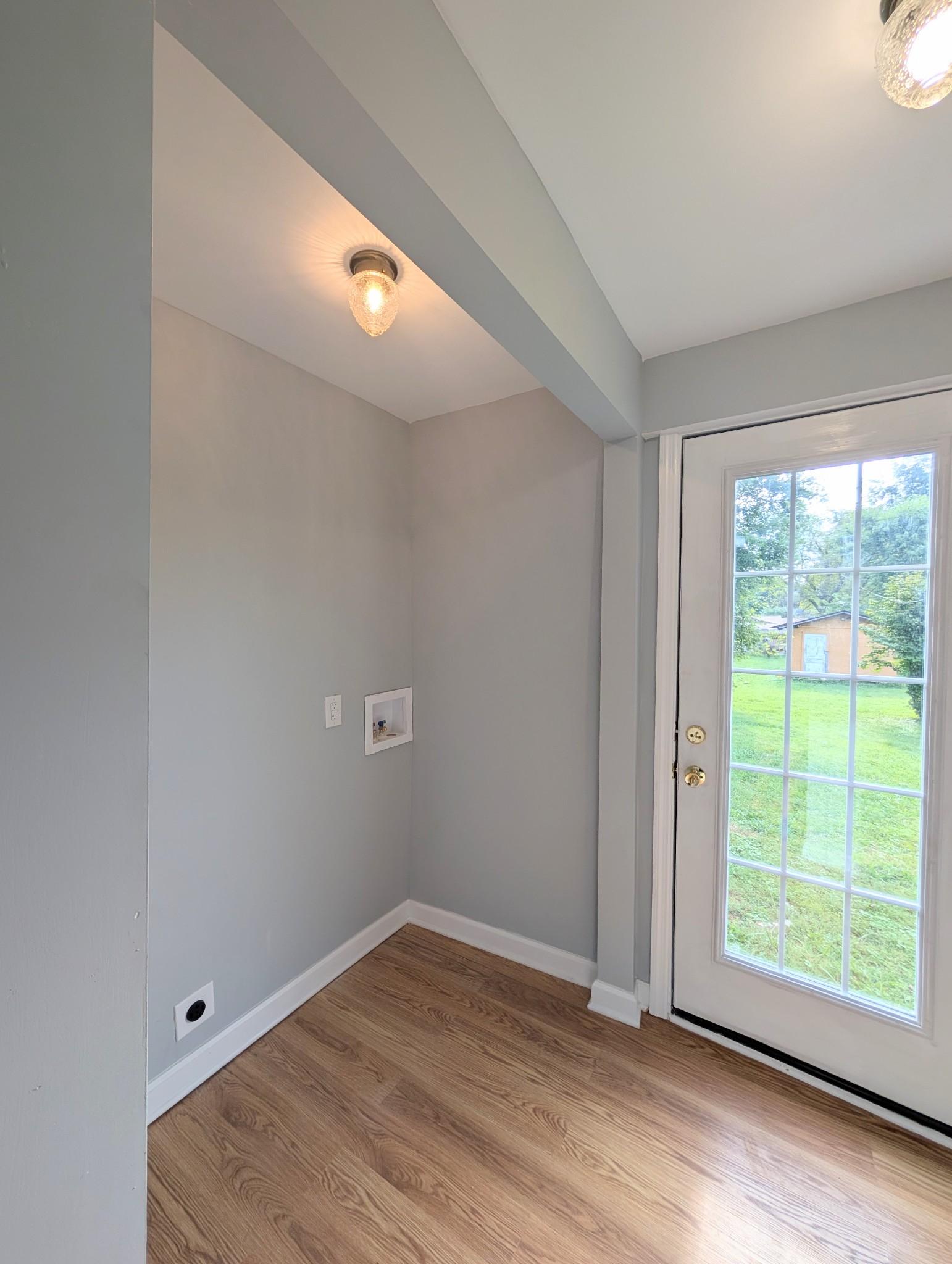 406 Horton Street Decherd, TN 37324 - Photo 23 of 24 an empty room with wooden floor and windows