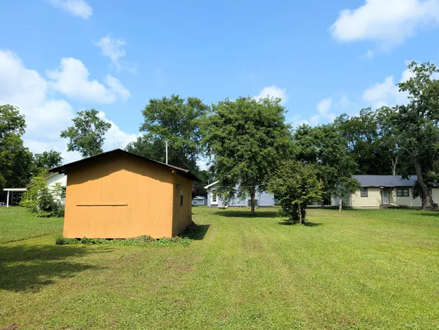 a view of an house with backyard space and garden