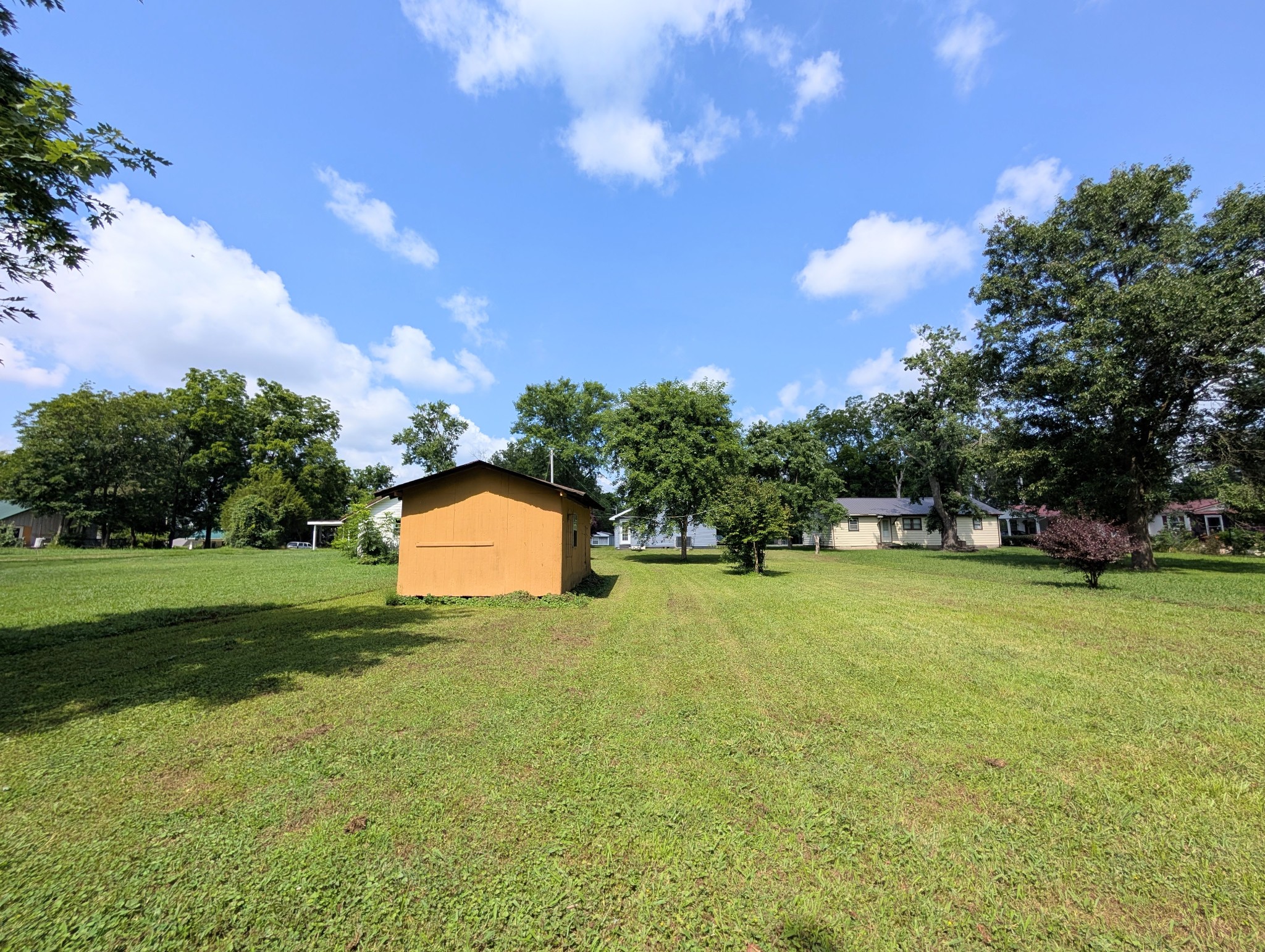 406 Horton Street Decherd, TN 37324 - Photo 10 of 24 a view of a big yard with swimming pool and green space