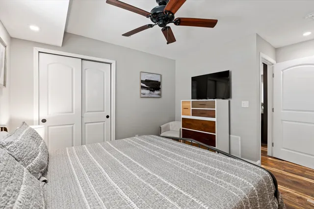 a bedroom with a bed and a flat screen tv