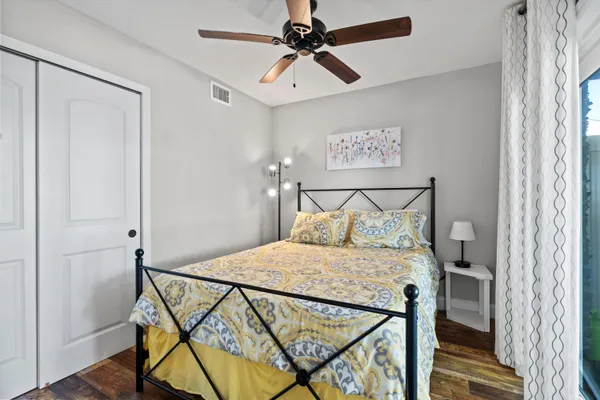 a bedroom with a bed a lamp and a chandelier