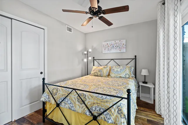 a bedroom with a bed a lamp and a chandelier