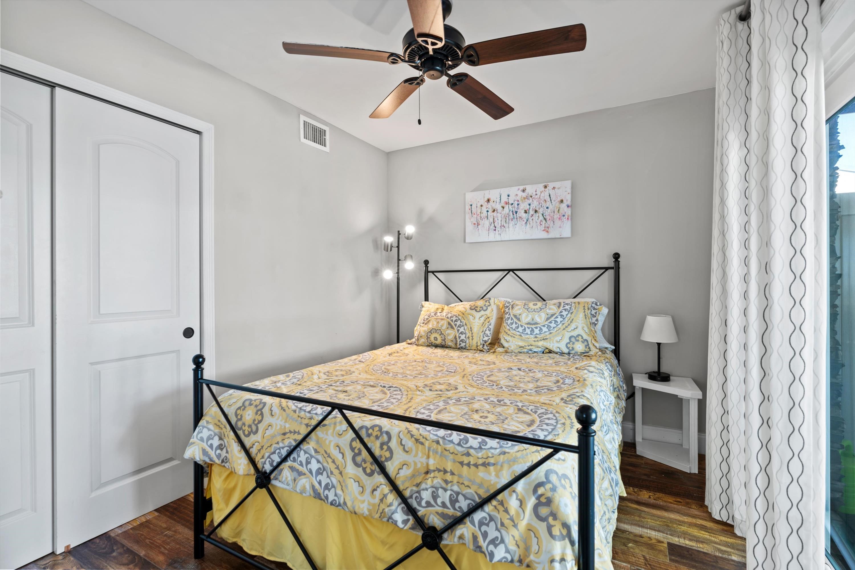 9 3rd Street St. Augustine, FL 32080 - Photo 15 of 25 a bedroom with a bed a lamp and a chandelier