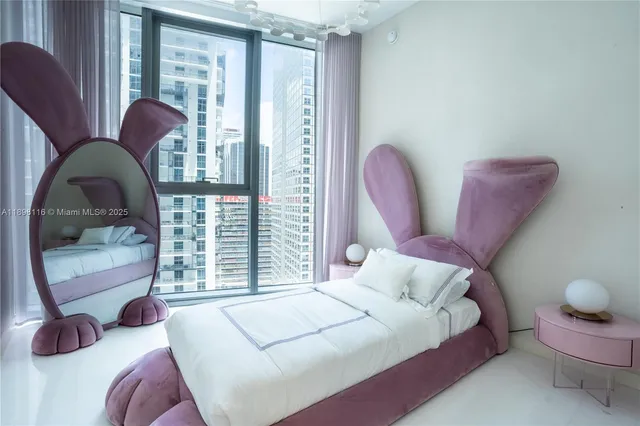 a bedroom with bed and a large window