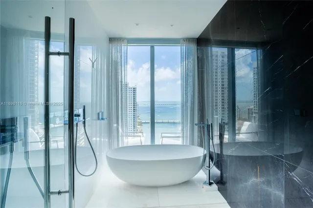 a bathroom with a bathtub and shower