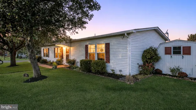 a front view of house with a garden
