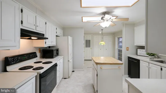 a kitchen with a sink stove and refrigerator