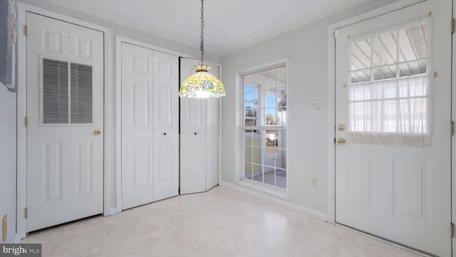 a view of a livingroom with a window and wooden floor
