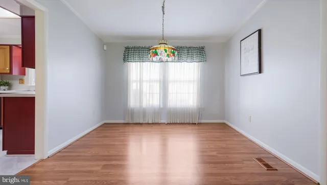 a view of a dining room with furniture and chandelier