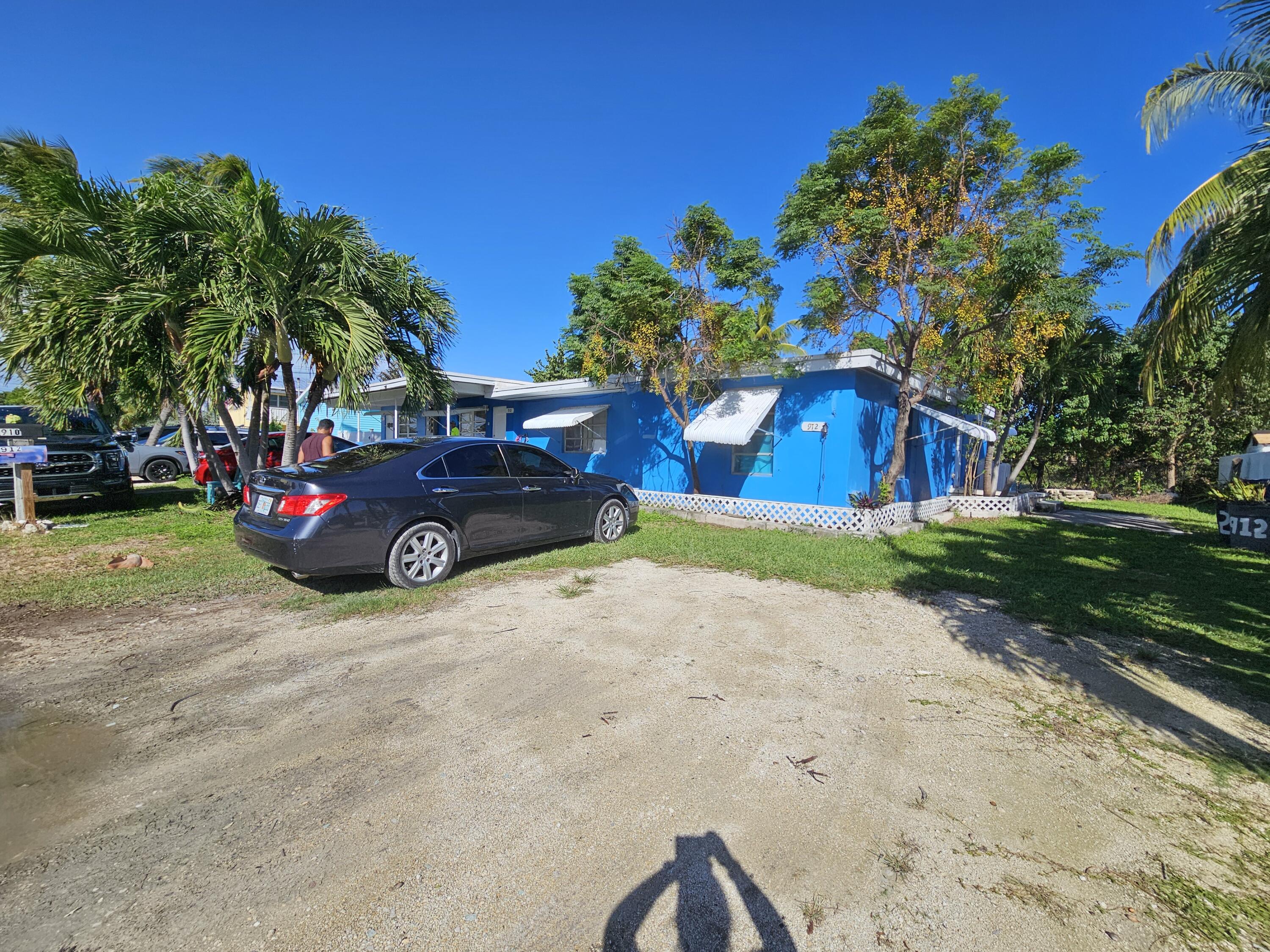 908 66th Street Marathon, FL 33050 - Photo 11 of 31 a car parked in front of a house and a yard