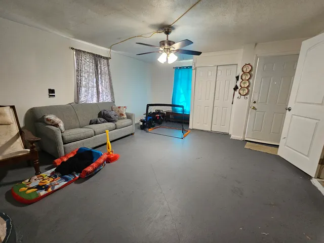 a living room with furniture and a chandelier