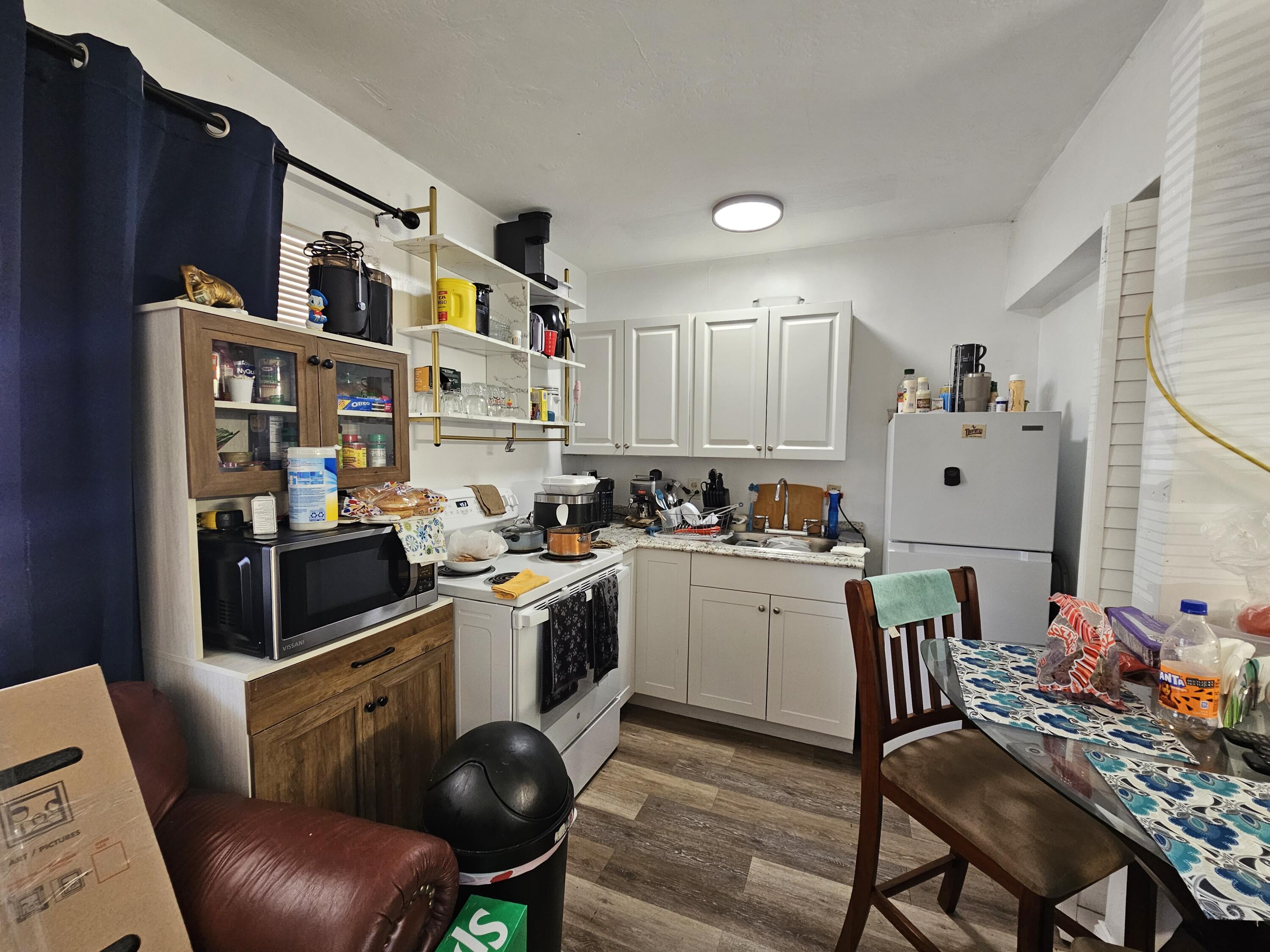 908 66th Street Marathon, FL 33050 - Photo 23 of 31 a kitchen with stainless steel appliances granite countertop a stove top oven a sink dishwasher and cabinets with wooden floor