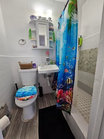 a bathroom with a sink toilet and shower