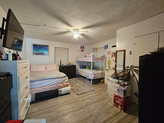 a bedroom with furniture and a flat screen tv