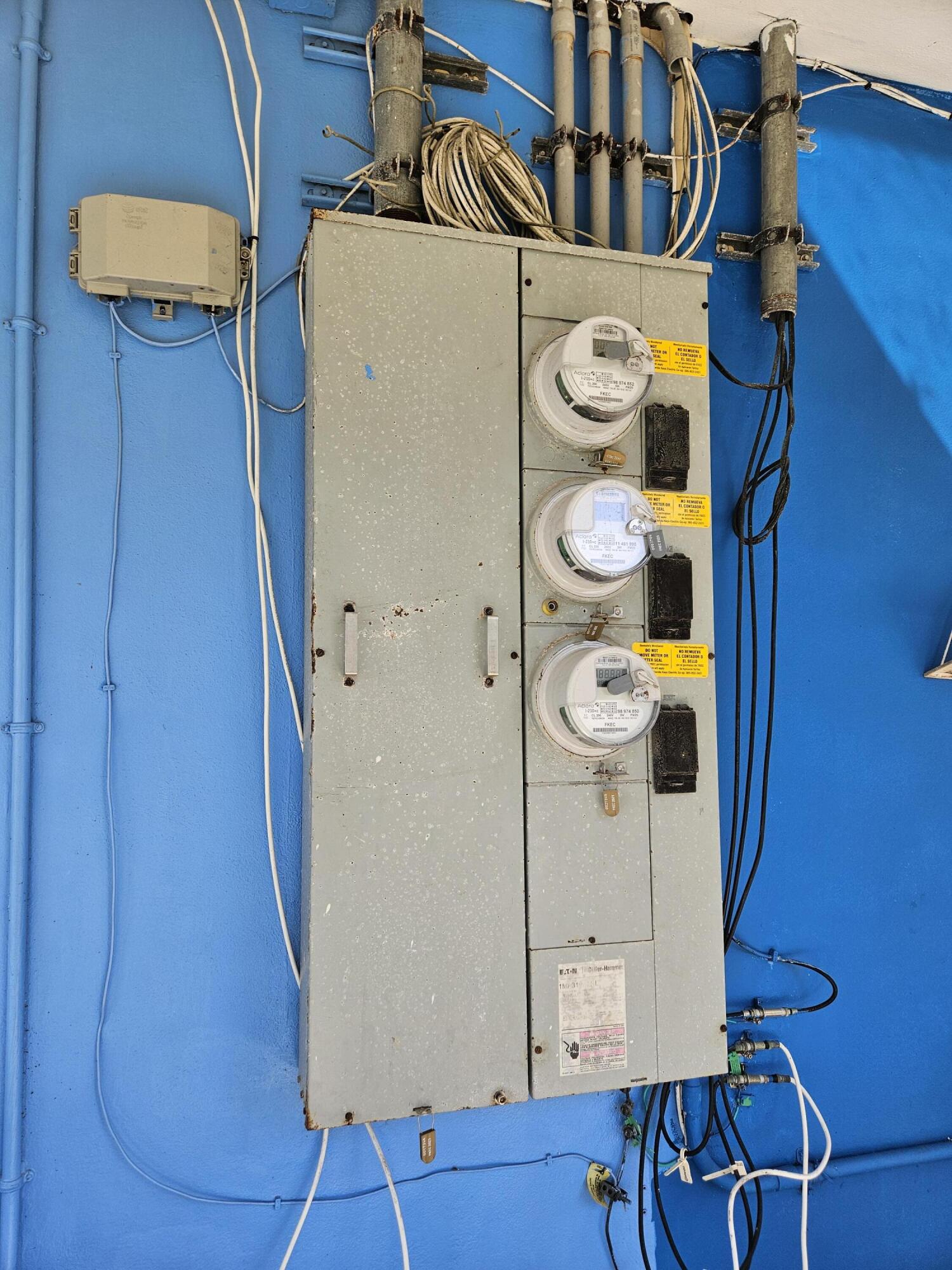 908 66th Street Marathon, FL 33050 - Photo 10 of 31 a white refrigerator freezer and a wooden table sitting inside of a room