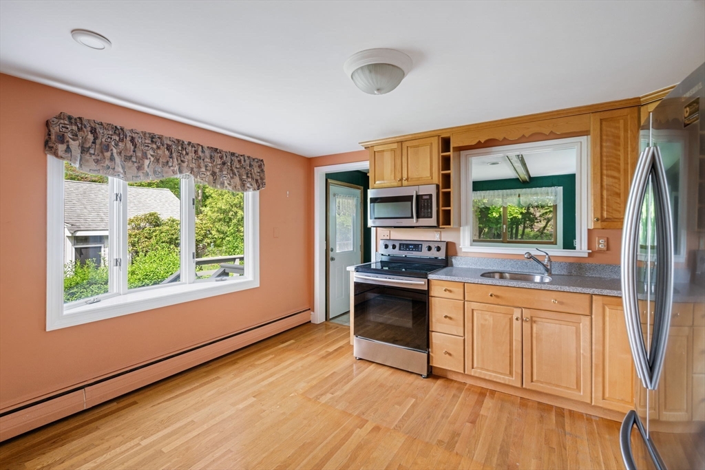 40 Bell Road Weymouth, MA 02188 - Photo 18 of 41 a kitchen with stainless steel appliances granite countertop a stove a sink and a refrigerator