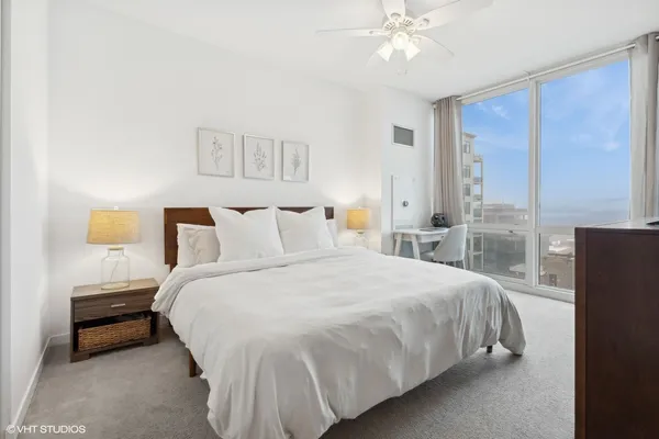 a bedroom with a bed and a chandelier