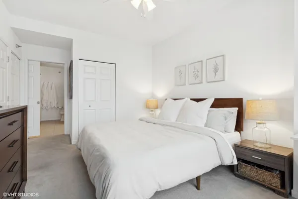a bedroom with a bed and a night stand