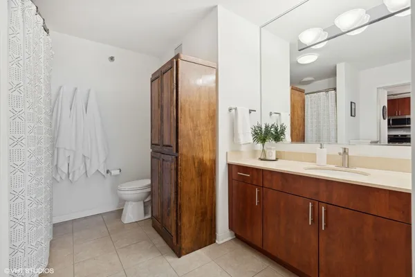 a bathroom with a double vanity sink toilet and shower
