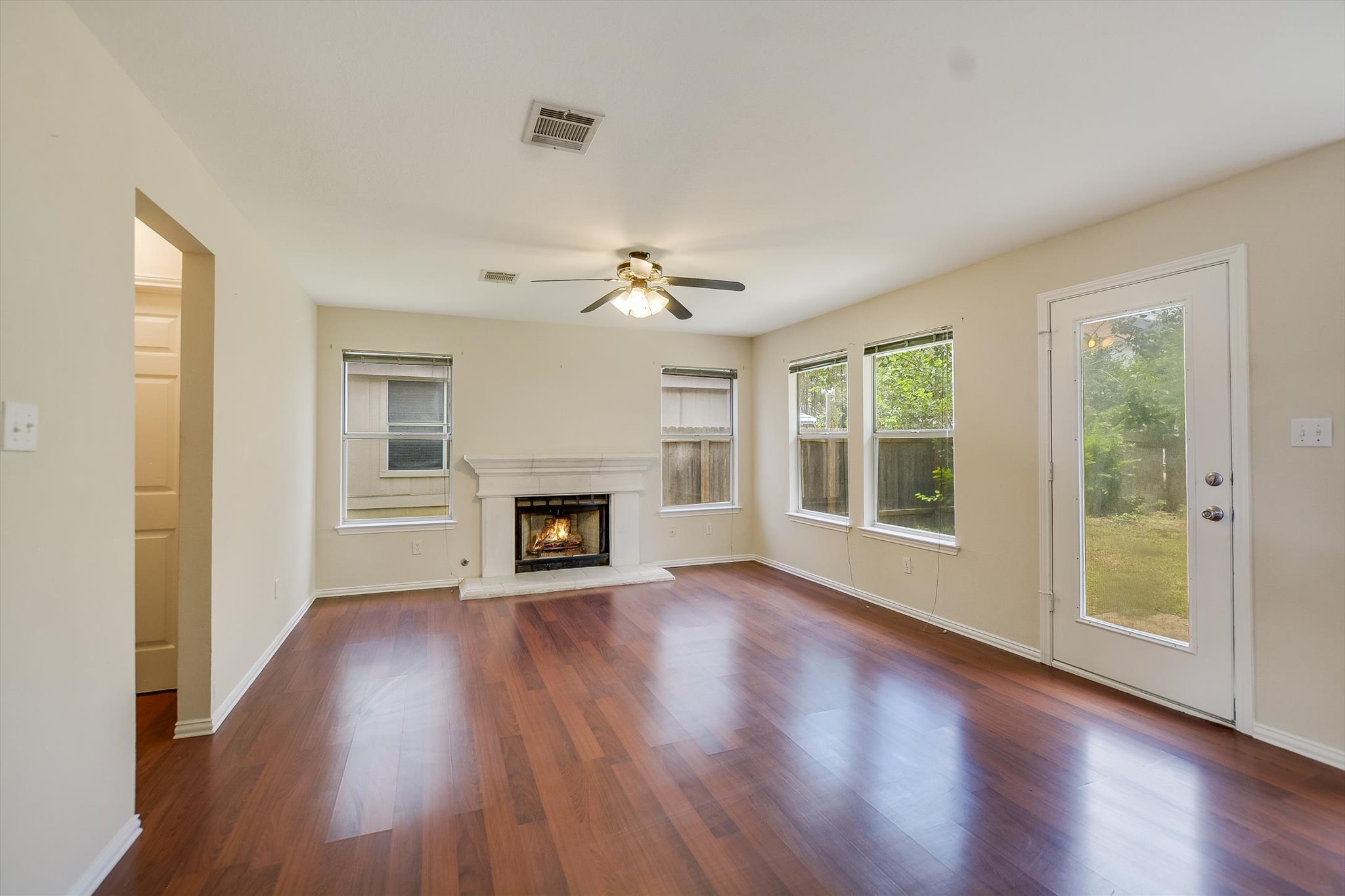 1008 Double File Trail Round Rock, TX 78665 - Photo 6 of 20 Warm hardwood floors and a cozy fireplace create a welcoming atmosphere in this spacious living area.