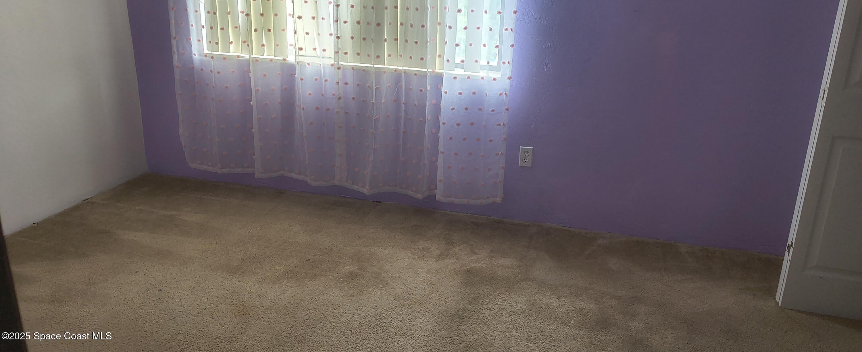 7801 Maplewood Drive, Unit 911 Melbourne, FL 32904 - Photo 11 of 16 an empty room with windows