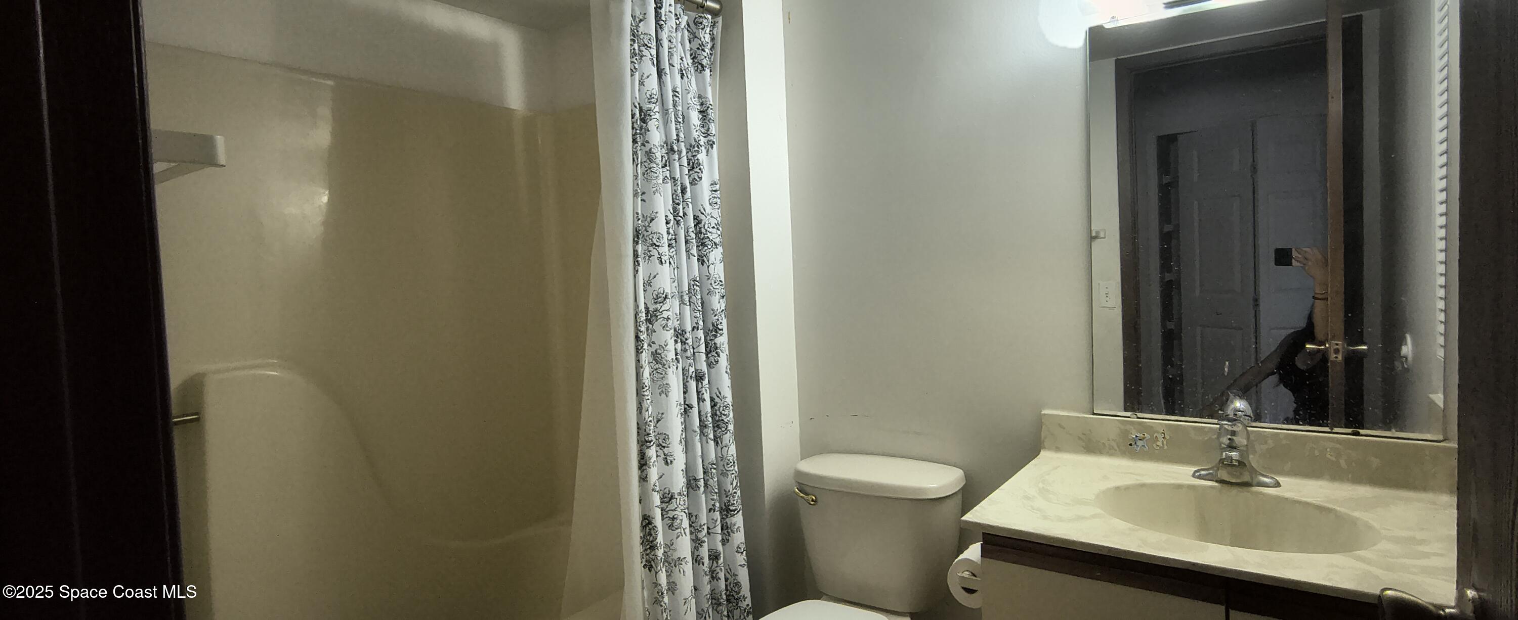 7801 Maplewood Drive, Unit 911 Melbourne, FL 32904 - Photo 14 of 16 a bathroom with a sink toilet and shower