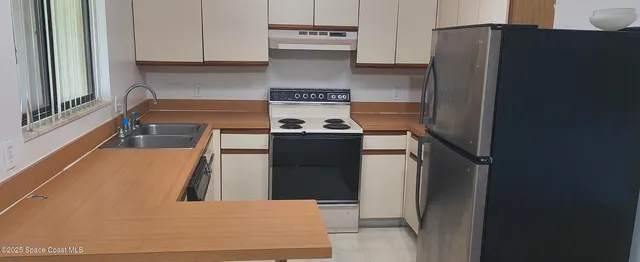 a kitchen with a stove and a refrigerator