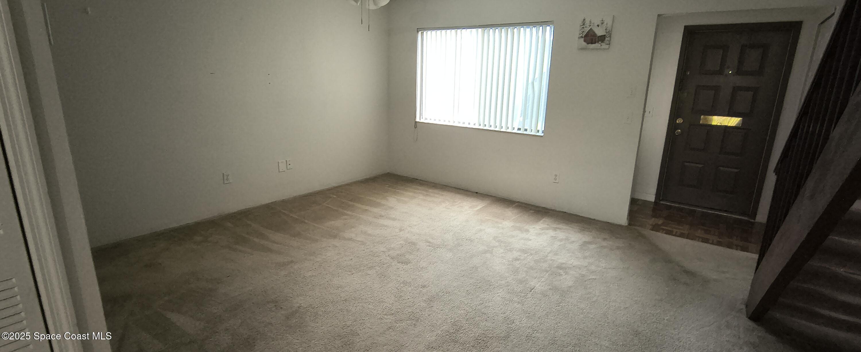 7801 Maplewood Drive, Unit 911 Melbourne, FL 32904 - Photo 4 of 16 an empty room with windows