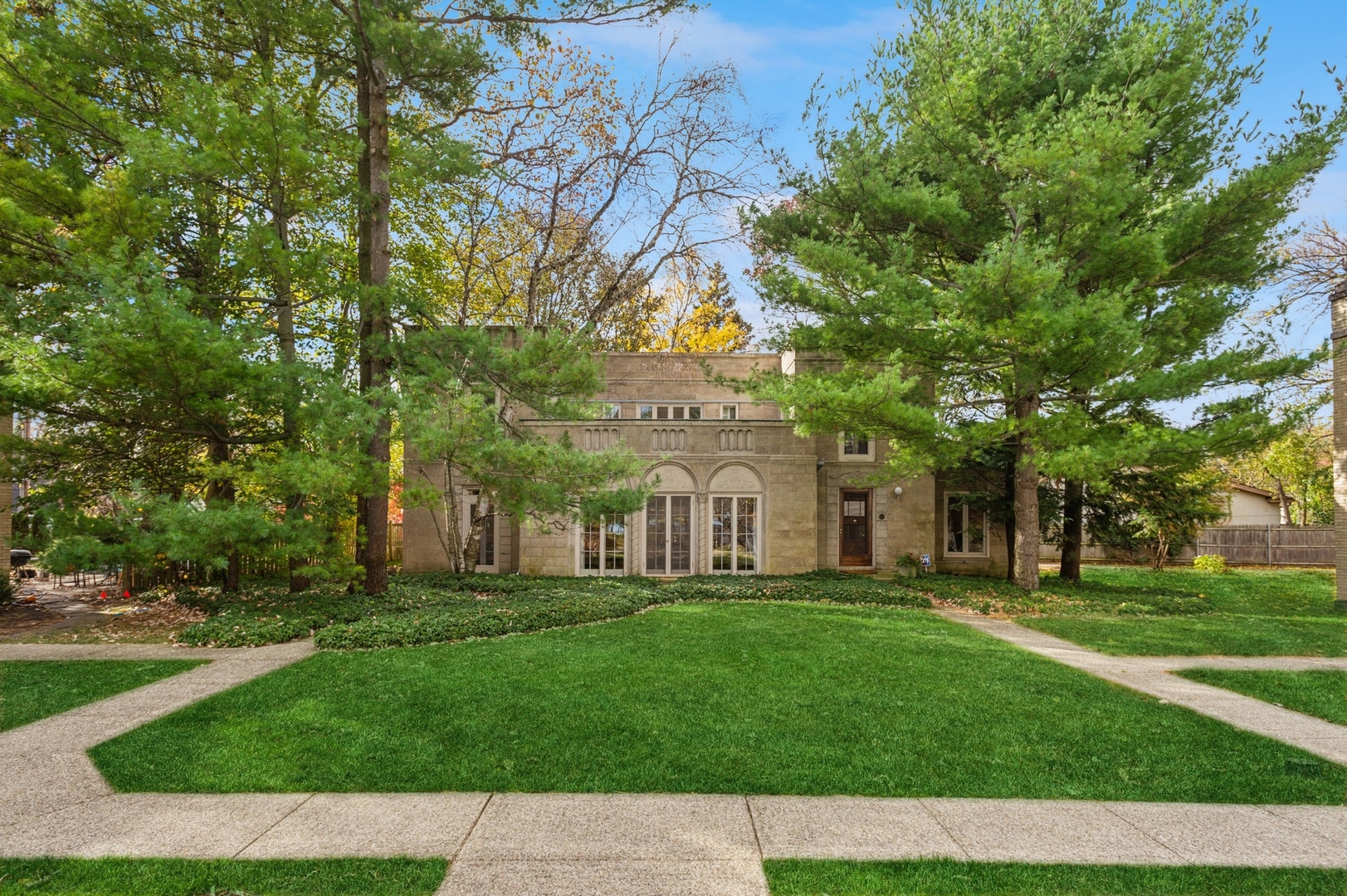 228 Sheridan Road Winnetka, IL 60093 - Photo 2 of 32 a front view of a building with a garden
