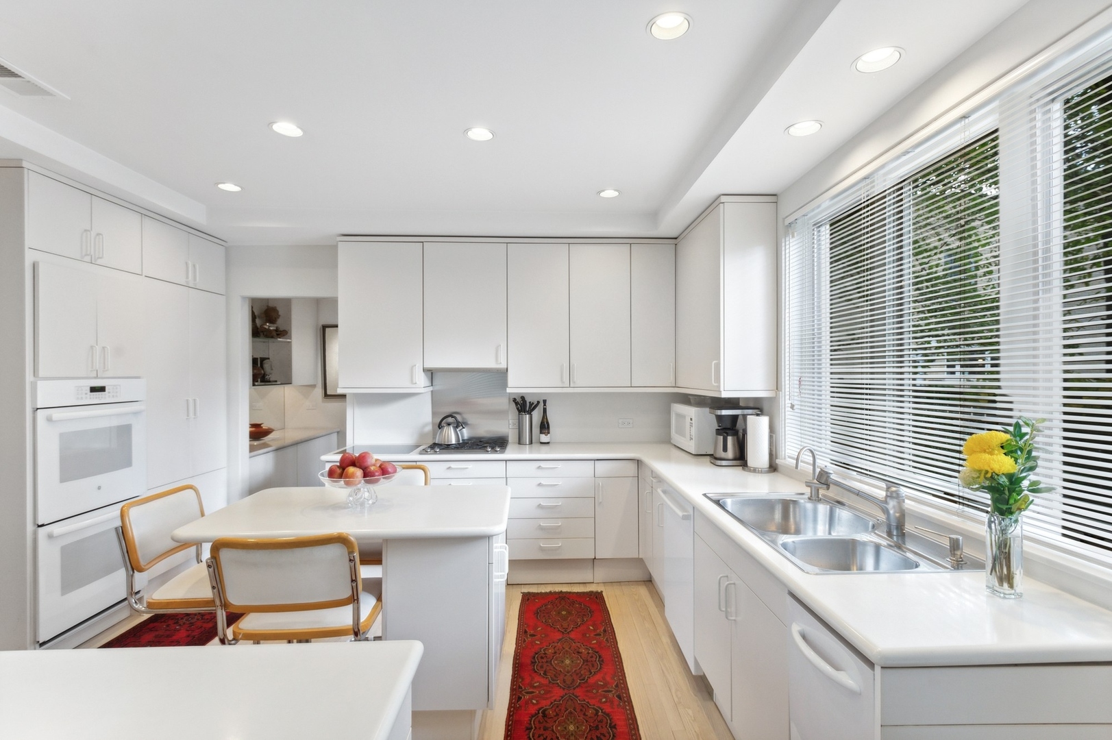 228 Sheridan Road Winnetka, IL 60093 - Photo 5 of 32 a kitchen that has a sink and chairs in it