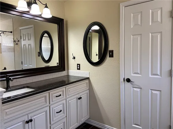 a bathroom with a sink and a mirror