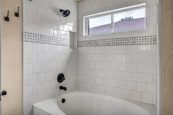 a bathroom with a granite countertop sink a toilet and a bathtub