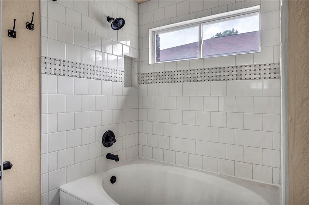 1257 Pine Portage Loop Leander, TX 78641 - Photo 27 of 32 Bathroom with a textured wall and shower combination