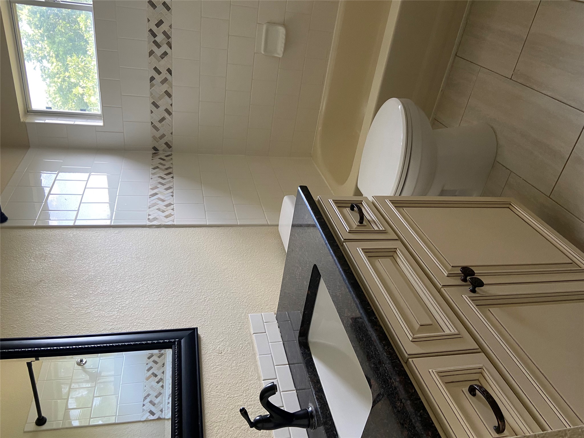 1257 Pine Portage Loop Leander, TX 78641 - Photo 28 of 32 Full bath featuring vanity, bathtub / shower combination, toilet, and a textured wall