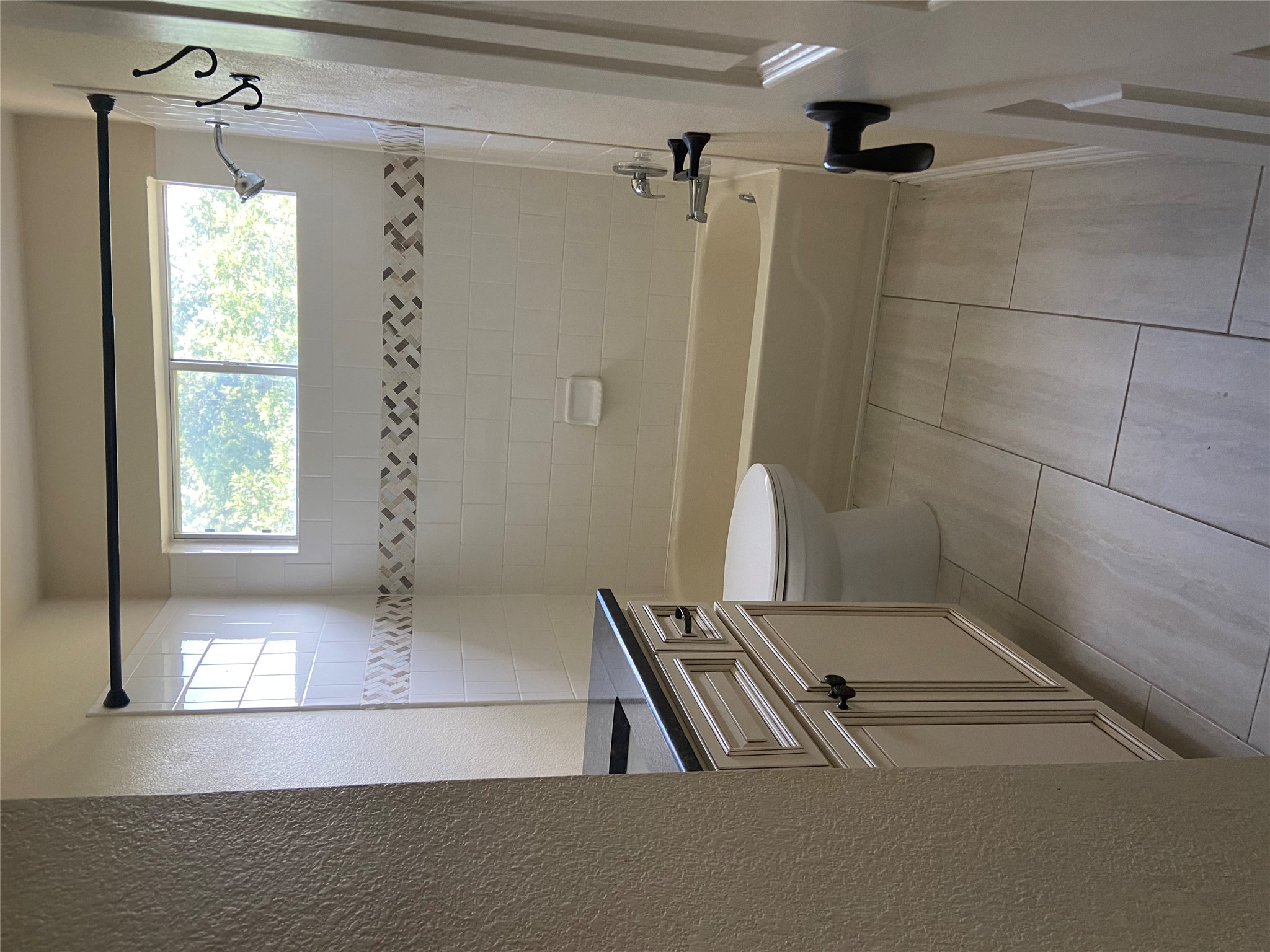 1257 Pine Portage Loop Leander, TX 78641 - Photo 29 of 32 Bathroom with washtub / shower combination, toilet, vanity, and a textured wall
tile flooring