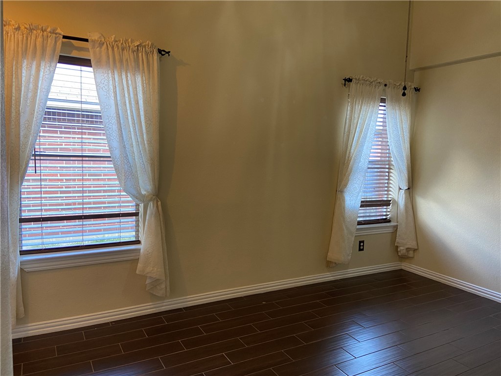 1257 Pine Portage Loop Leander, TX 78641 - Photo 3 of 32 Enter into the Family room with dark wood tiled floors and plenty of natural light