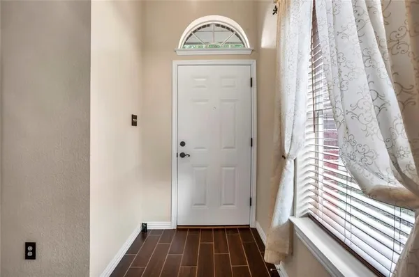 a view of front door with wooden floor